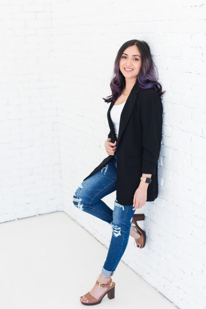 Woman smiling and leaning against the wall